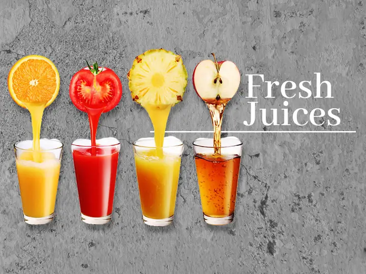 Glasses of fresh orange, tomato, pineapple and apple juice