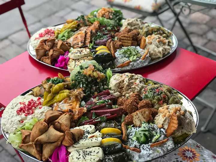 Sharing platters of mezza with falafel, salads and dips